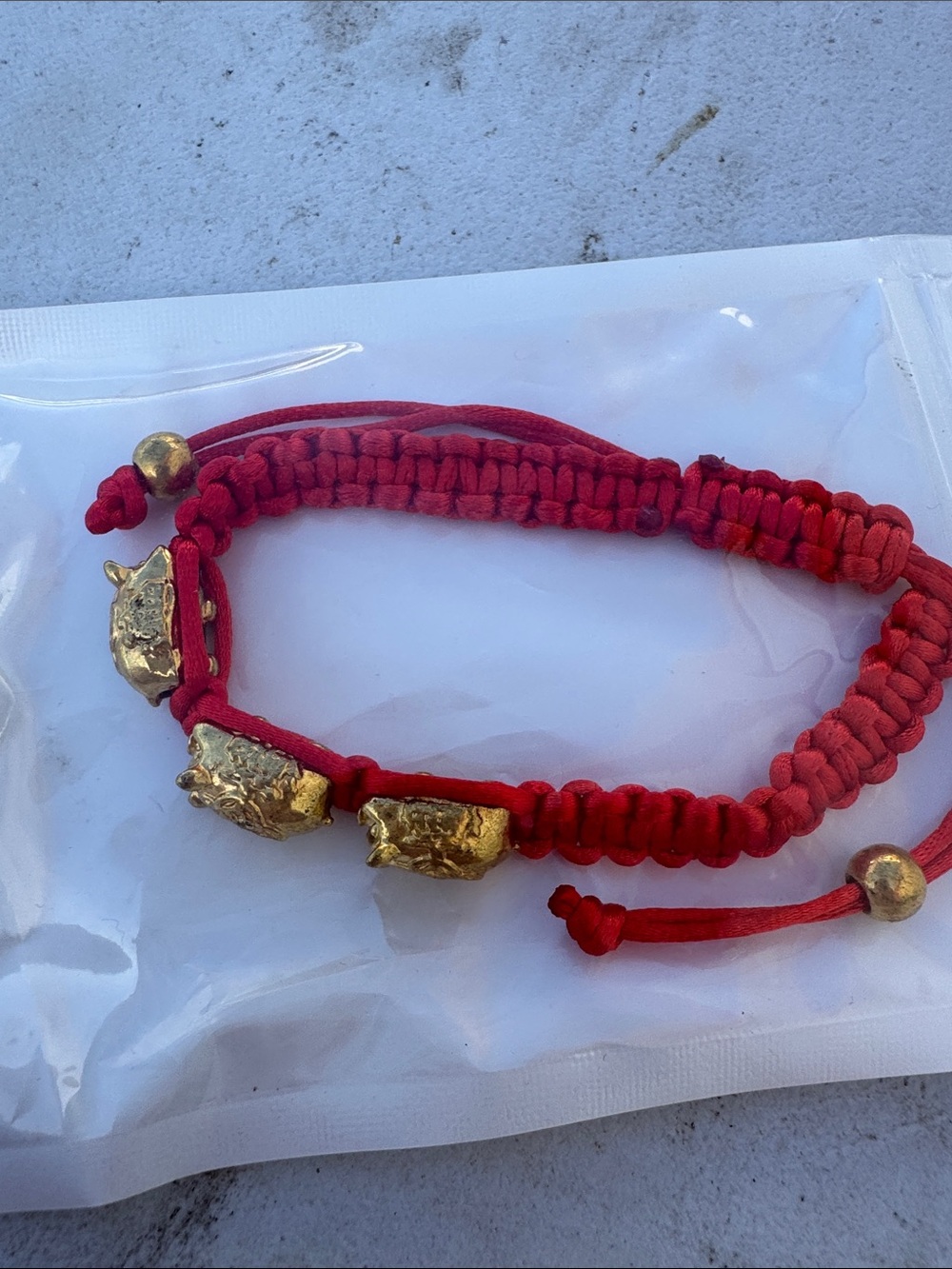 Red Braided Bracelet with Gold Bead and Charm Accents